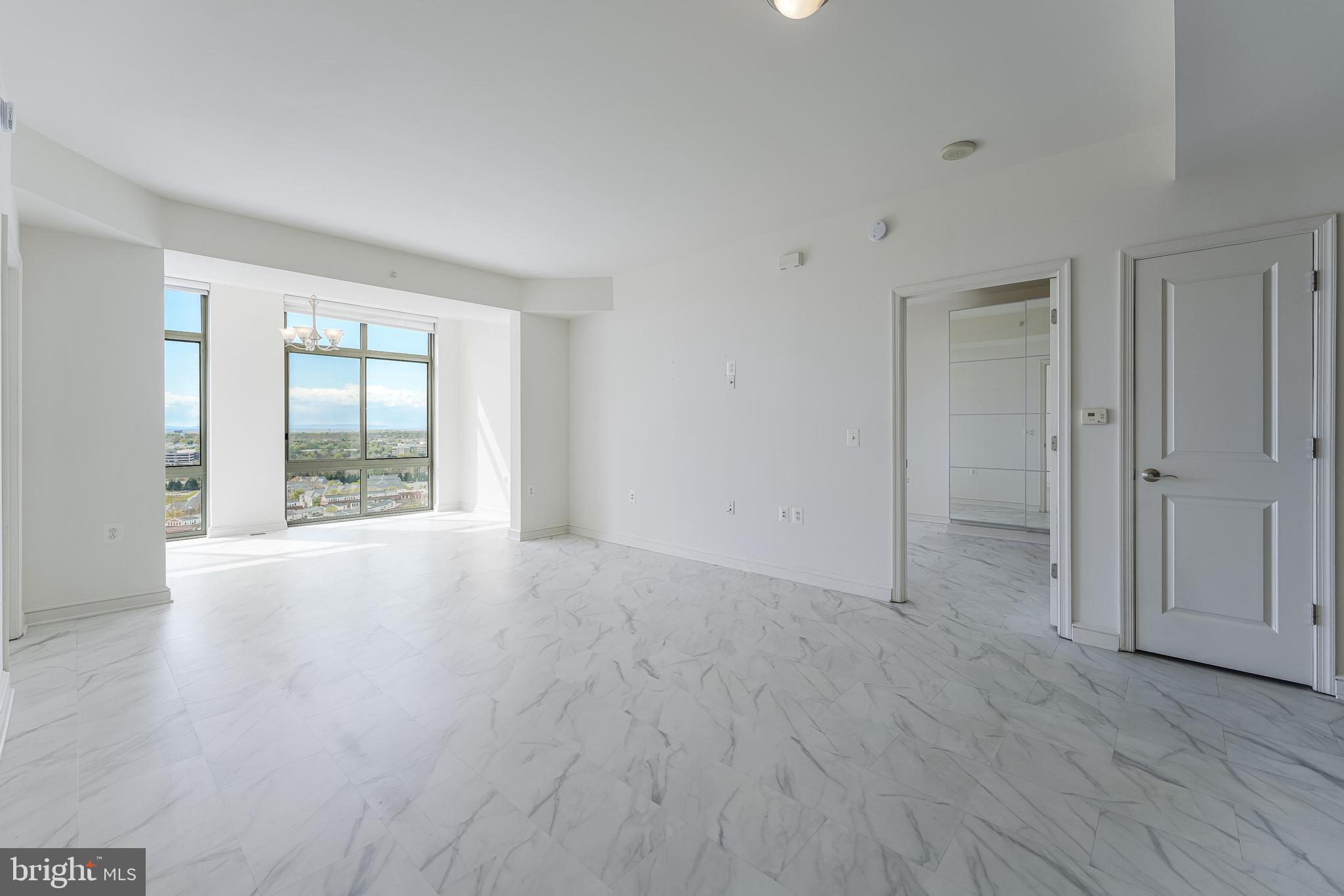11990 Market Street, Unit 1414 Reston, VA 20190 - Photo 5 of 65 wooden floor in an empty room with a window