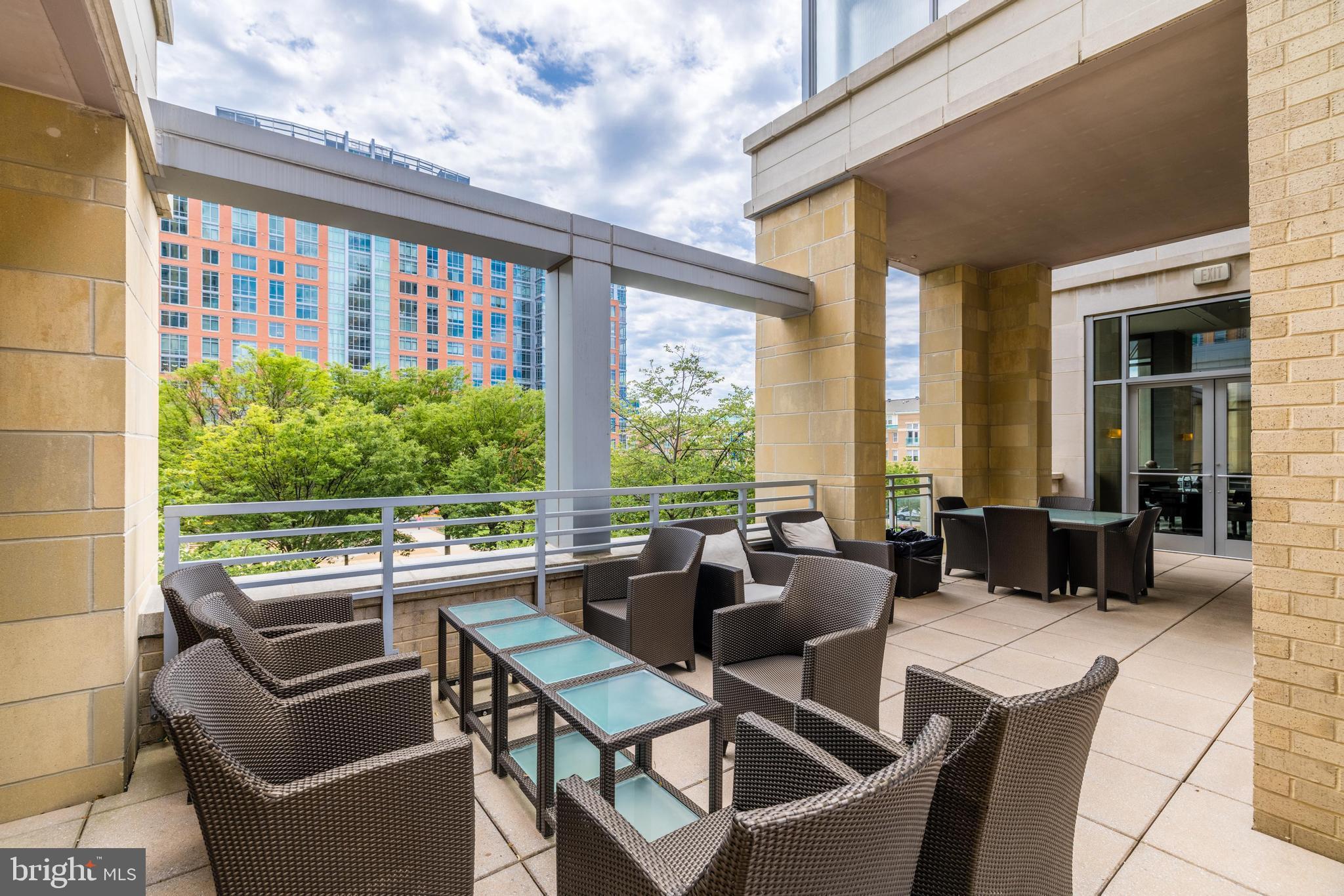 11990 Market Street, Unit 1414 Reston, VA 20190 - Photo 56 of 65 a view of a patio with couches chairs dining table and chairs