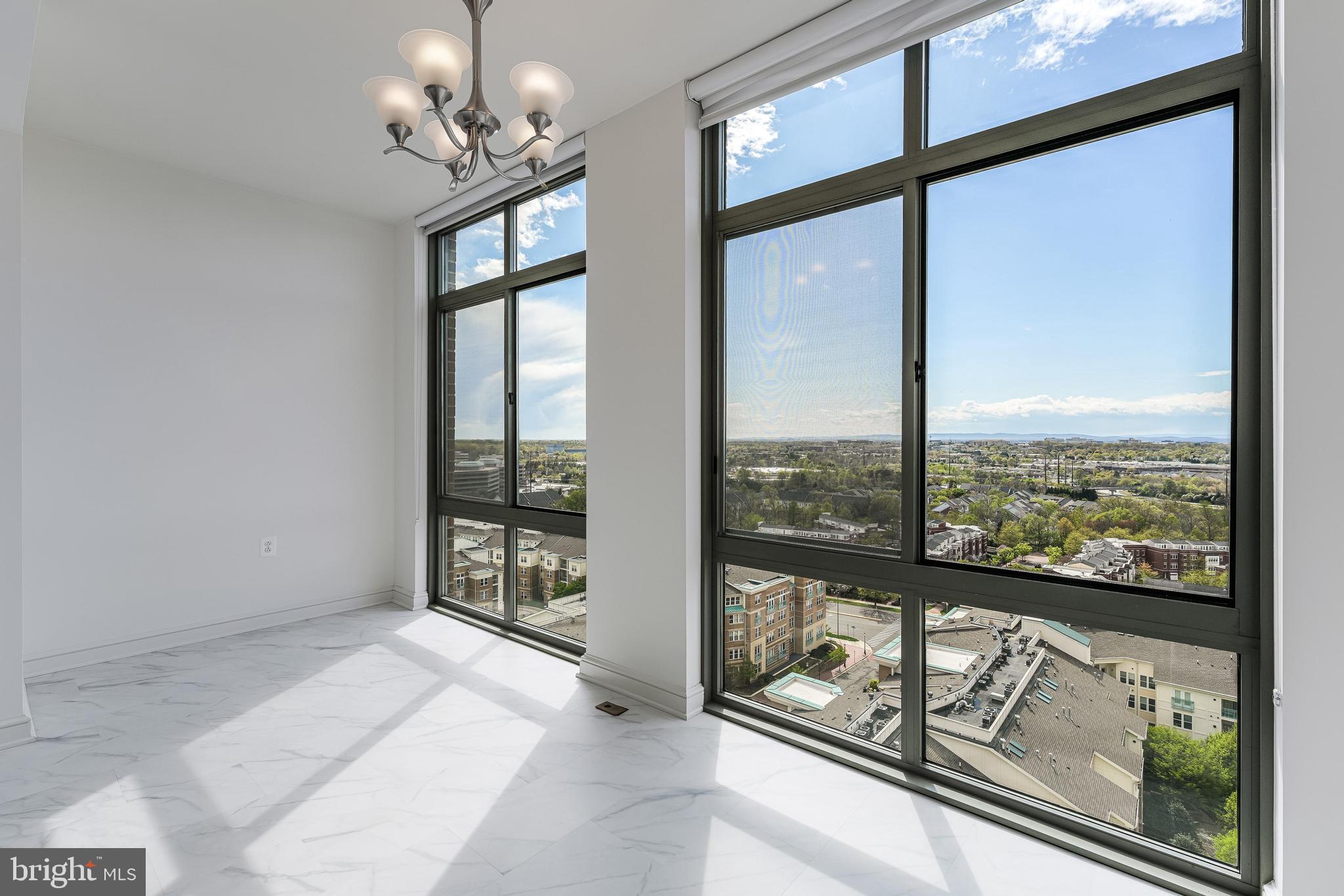 11990 Market Street, Unit 1414 Reston, VA 20190 - Photo 10 of 65 a view of an empty room with windows