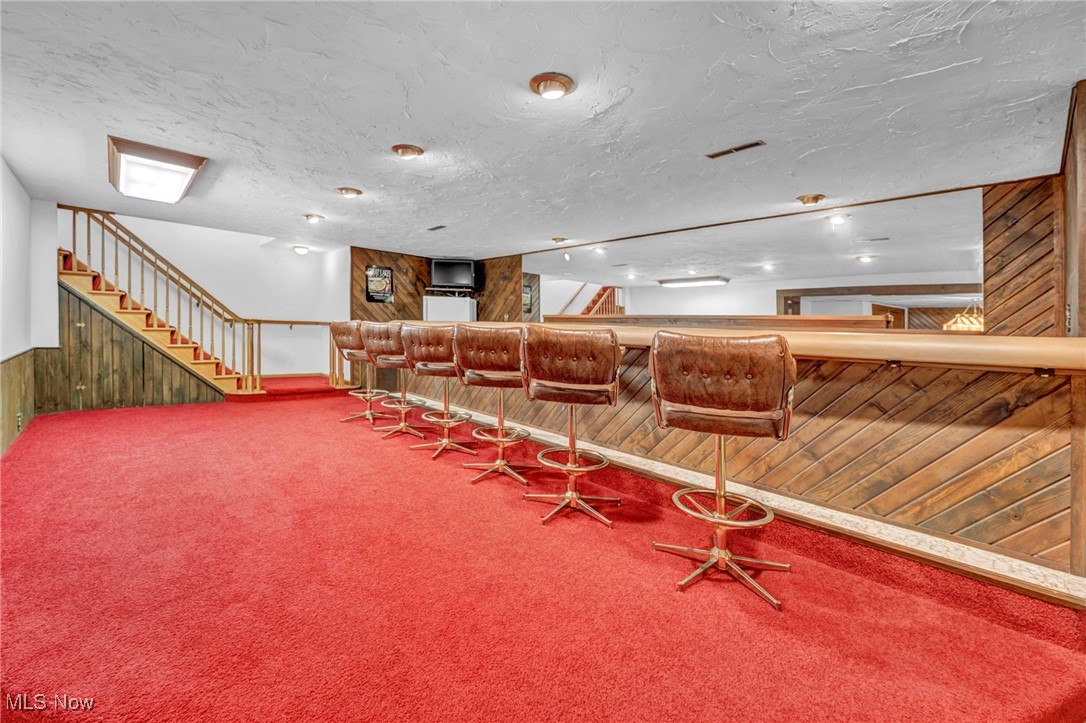 36350 Bainbridge Road Solon, OH 44139 - Photo 22 of 38 wooden walls, carpet flooring, and bar