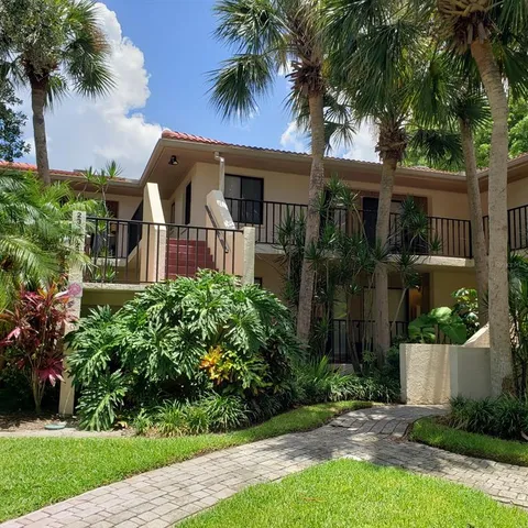 a front view of house with a garden