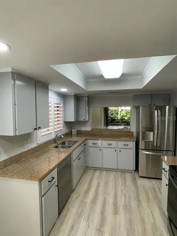 a kitchen with a sink and refrigerator