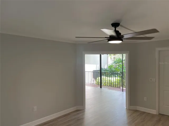 a view of an empty room and wooden floor
