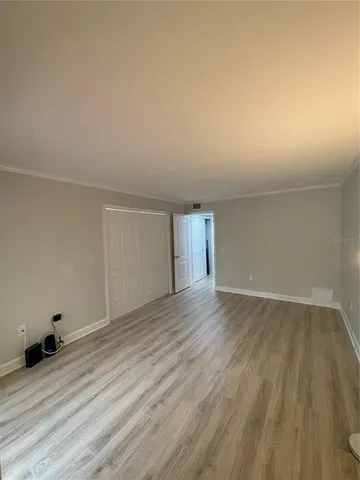 a view of an empty room and wooden floor