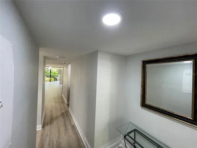 a view of a hallway with wooden floor