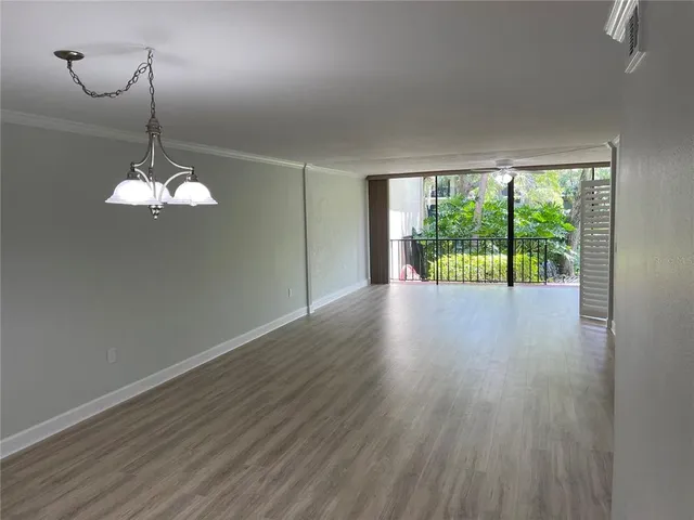 a view of a room with wooden floor water view and a window