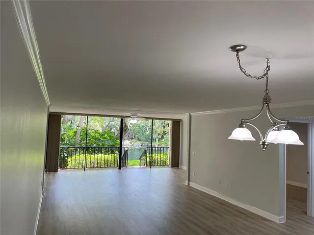 a view of a room with wooden floor and city view