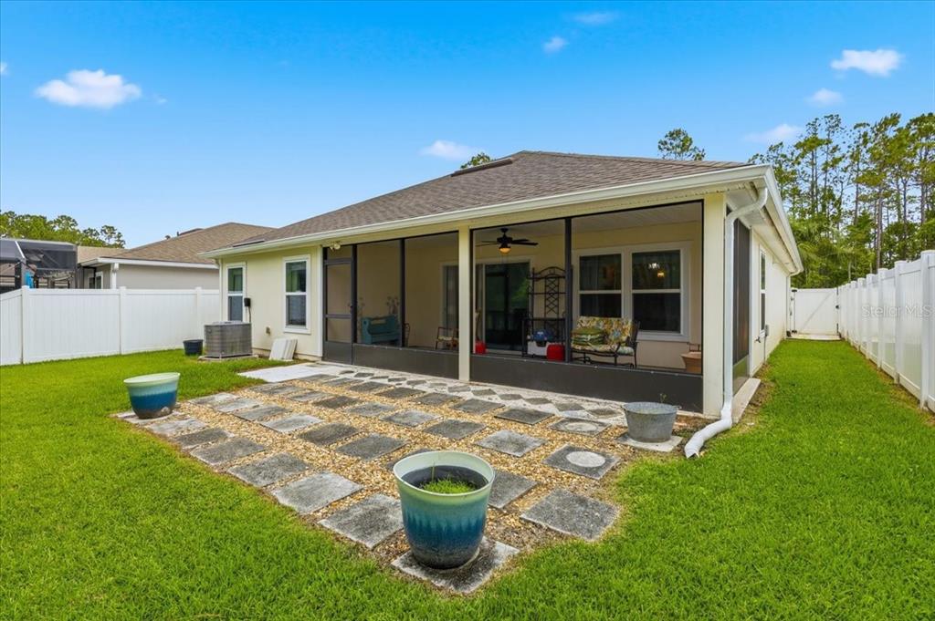 35 Birdie Way Bunnell, FL 32110 - Photo 42 of 57 a view of a house with backyard sitting area and garden