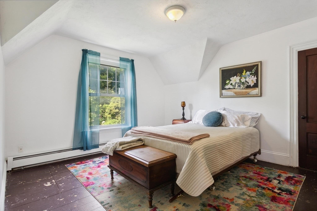 7 Spring Street Spencer, MA 01562 - Photo 18 of 38 a bed sitting in a bedroom next to a window