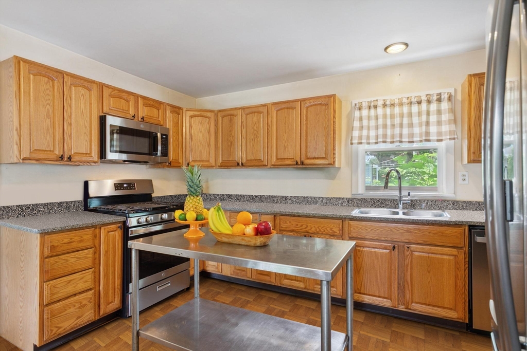 7 Spring Street Spencer, MA 01562 - Photo 2 of 38 a kitchen with a stove a sink and a microwave