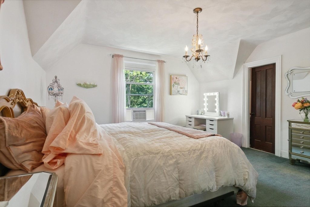 7 Spring Street Spencer, MA 01562 - Photo 21 of 38 a bedroom with a bed and a chandelier