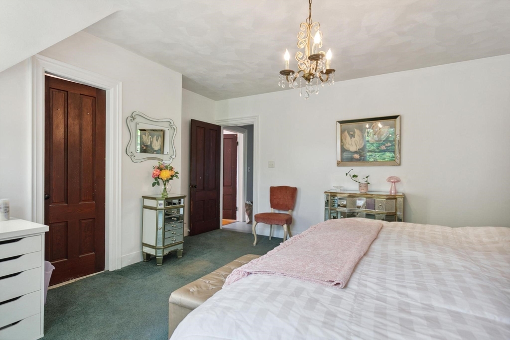 7 Spring Street Spencer, MA 01562 - Photo 22 of 38 a spacious bedroom with a bed and a chandelier