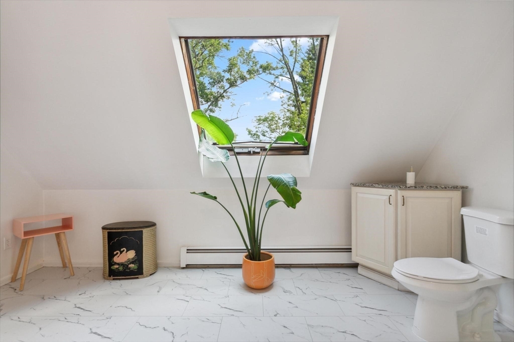 7 Spring Street Spencer, MA 01562 - Photo 26 of 38 a view of living room with washer and a potted plant