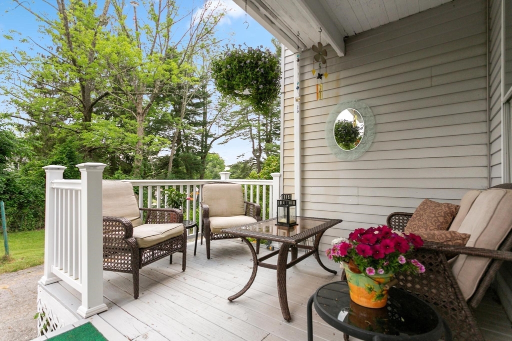 7 Spring Street Spencer, MA 01562 - Photo 30 of 38 a balcony with couple of chairs and potted plants