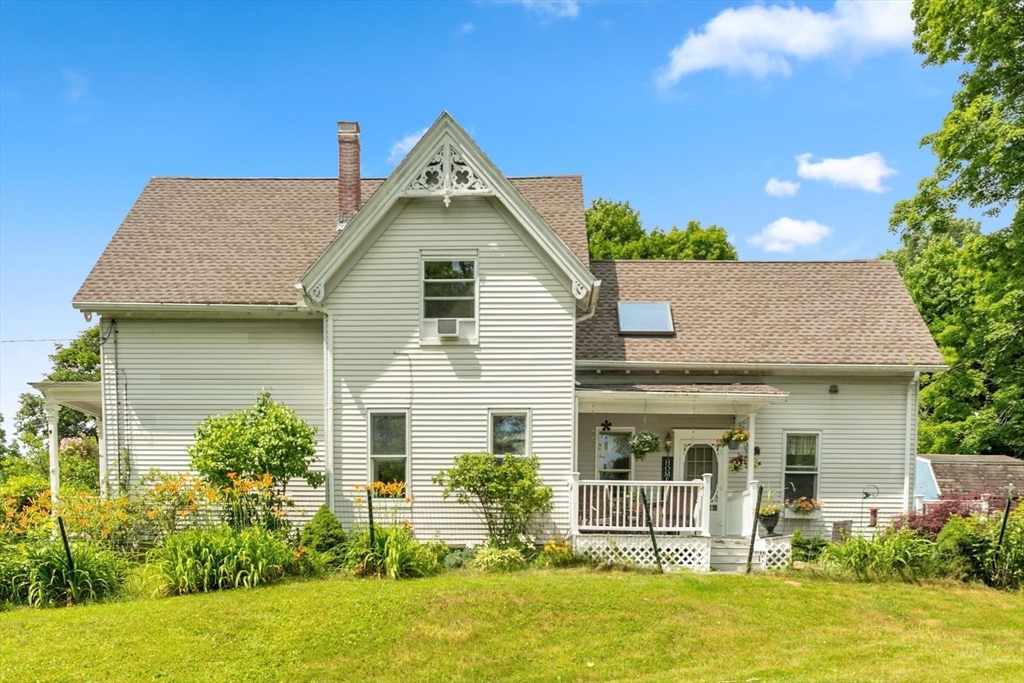 7 Spring Street Spencer, MA 01562 - Photo 32 of 38 a front view of a house with a yard