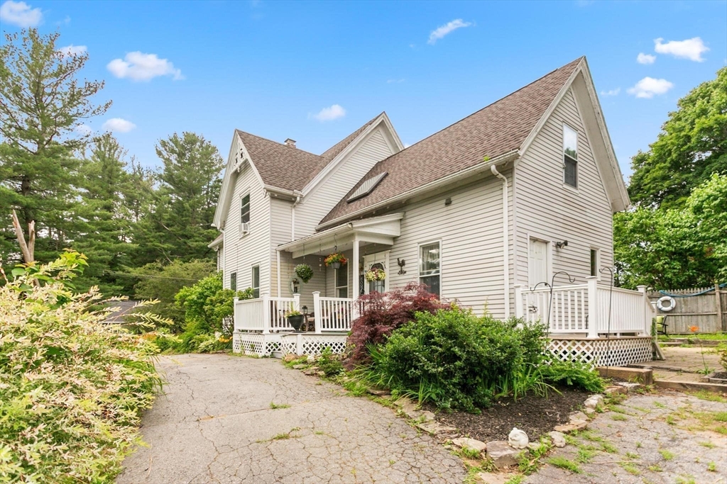 7 Spring Street Spencer, MA 01562 - Photo 34 of 38 a view of a house with a yard and plants