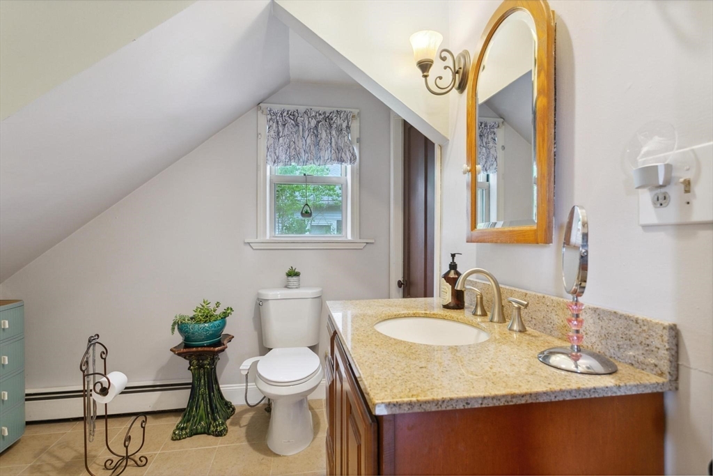 7 Spring Street Spencer, MA 01562 - Photo 9 of 38 a bathroom with a granite countertop sink a toilet and a mirror