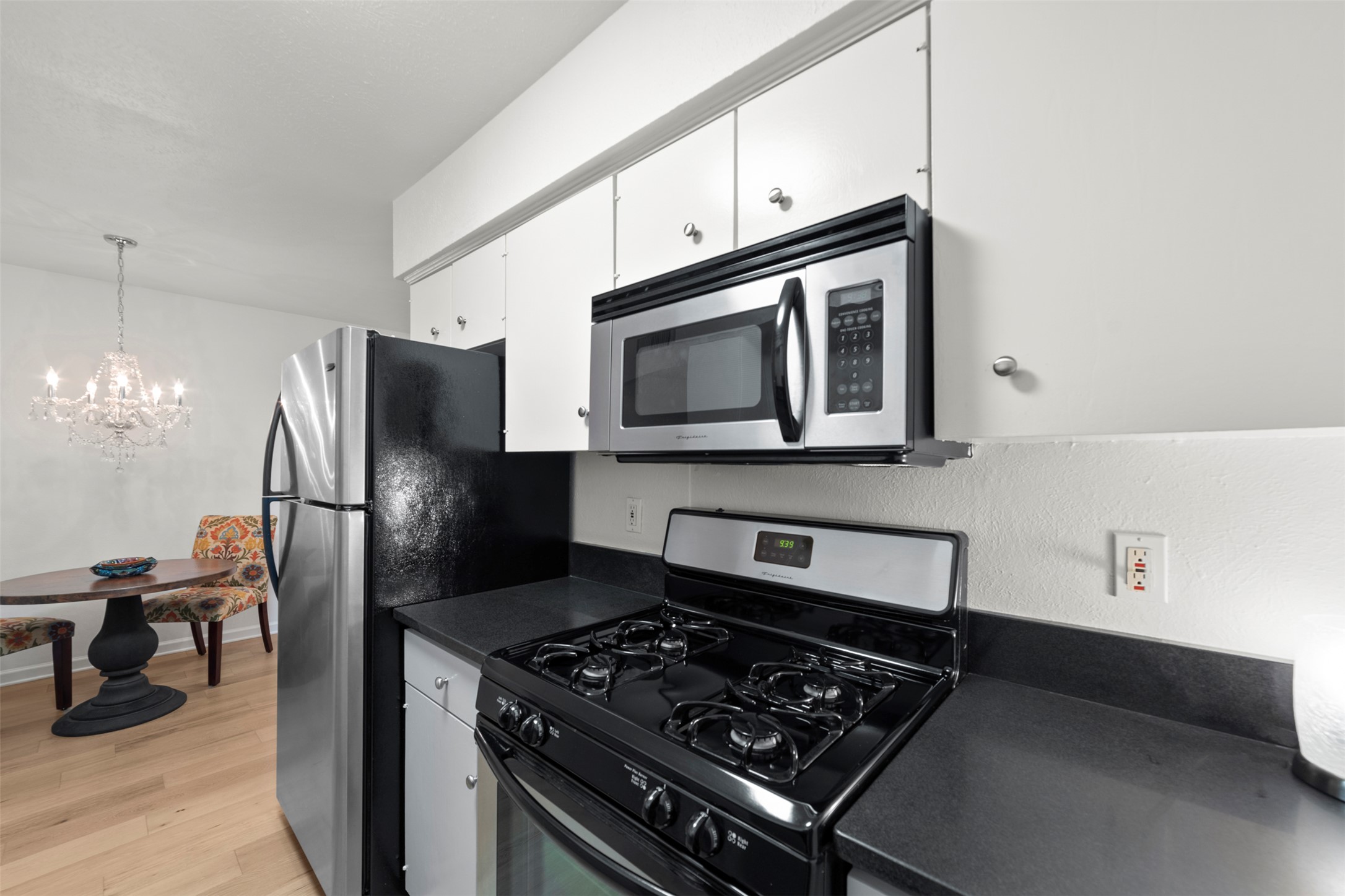 505 West 7th Street, Unit 113 Austin, TX 78701 - Photo 12 of 26 a kitchen with stainless steel appliances granite countertop a stove a refrigerator and a microwave