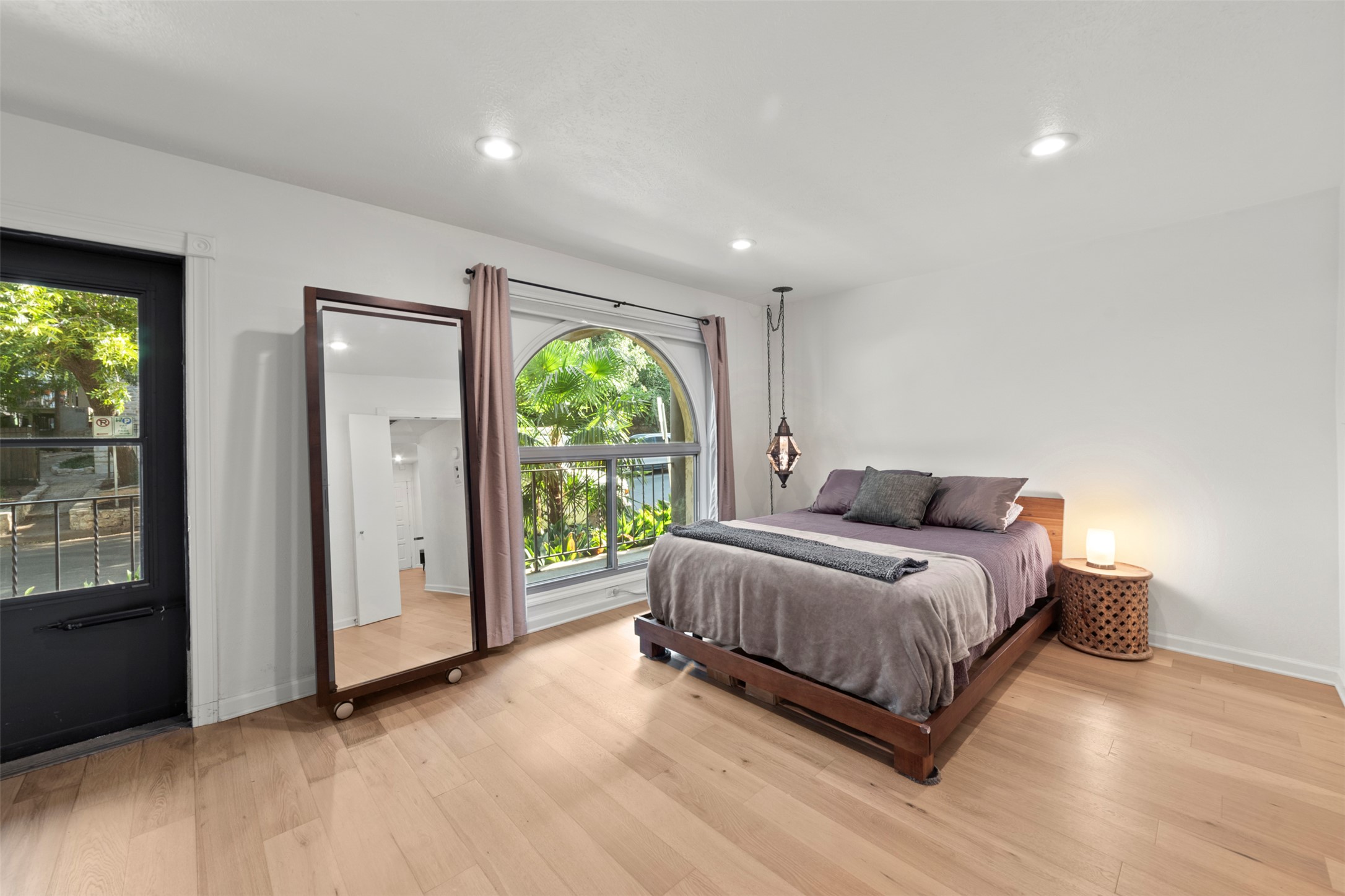 505 West 7th Street, Unit 113 Austin, TX 78701 - Photo 14 of 26 a spacious bedroom with a bed and large windows