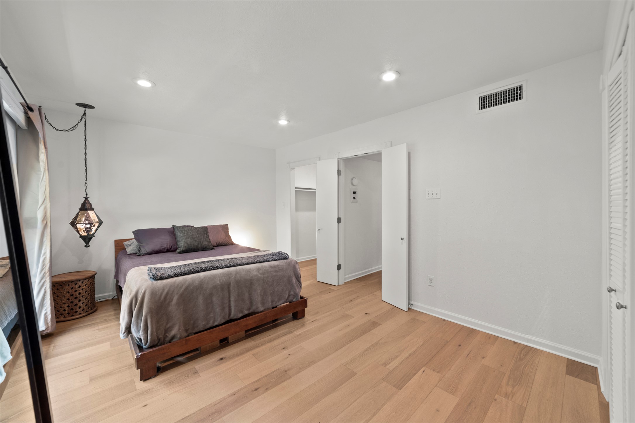 505 West 7th Street, Unit 113 Austin, TX 78701 - Photo 15 of 26 a bedroom with a bed and a mirror