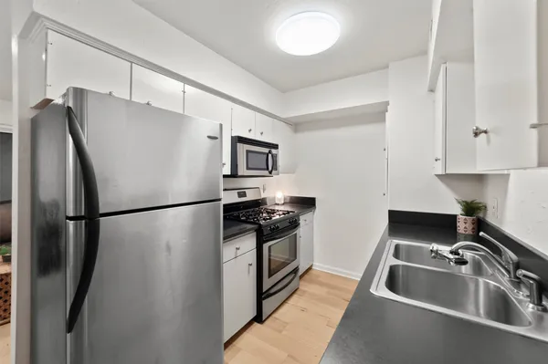 a kitchen with stainless steel appliances a refrigerator sink and stove