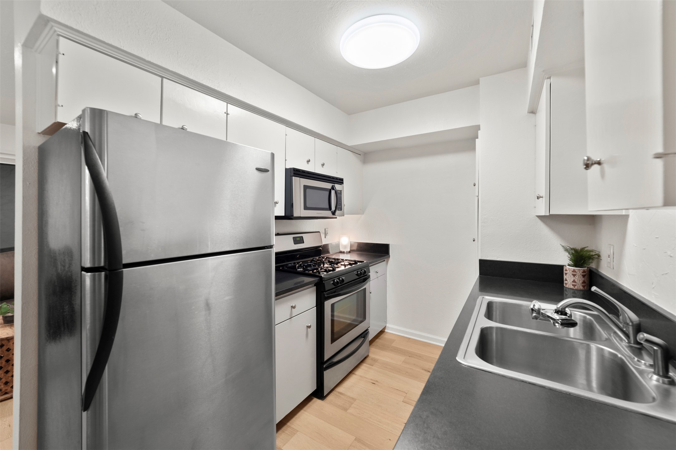 505 West 7th Street, Unit 113 Austin, TX 78701 - Photo 10 of 26 a kitchen with stainless steel appliances a refrigerator sink and stove