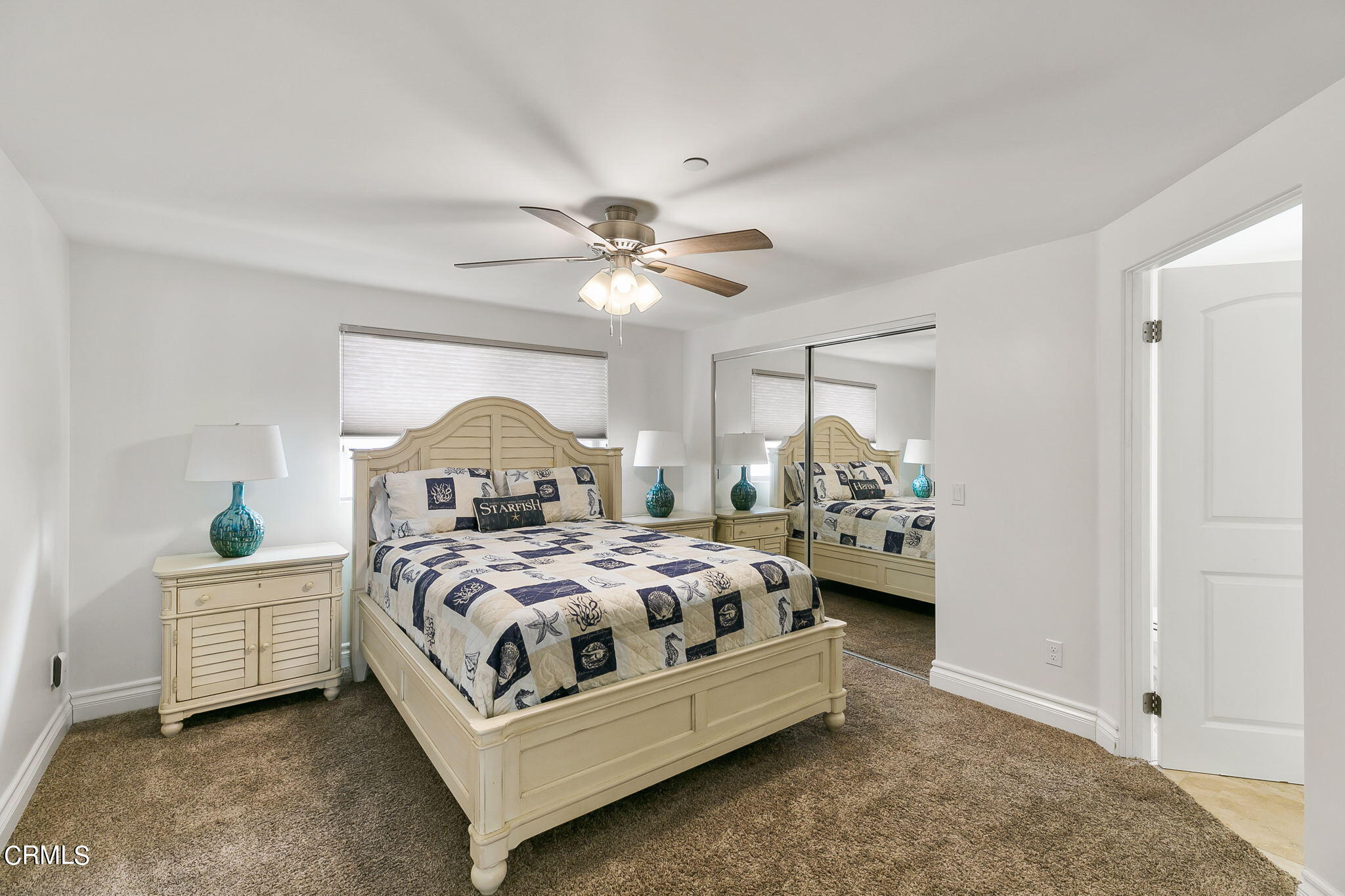 3224 Ocean Drive Oxnard, CA 93035 - Photo 30 of 52 a bedroom with a bed and a chandelier