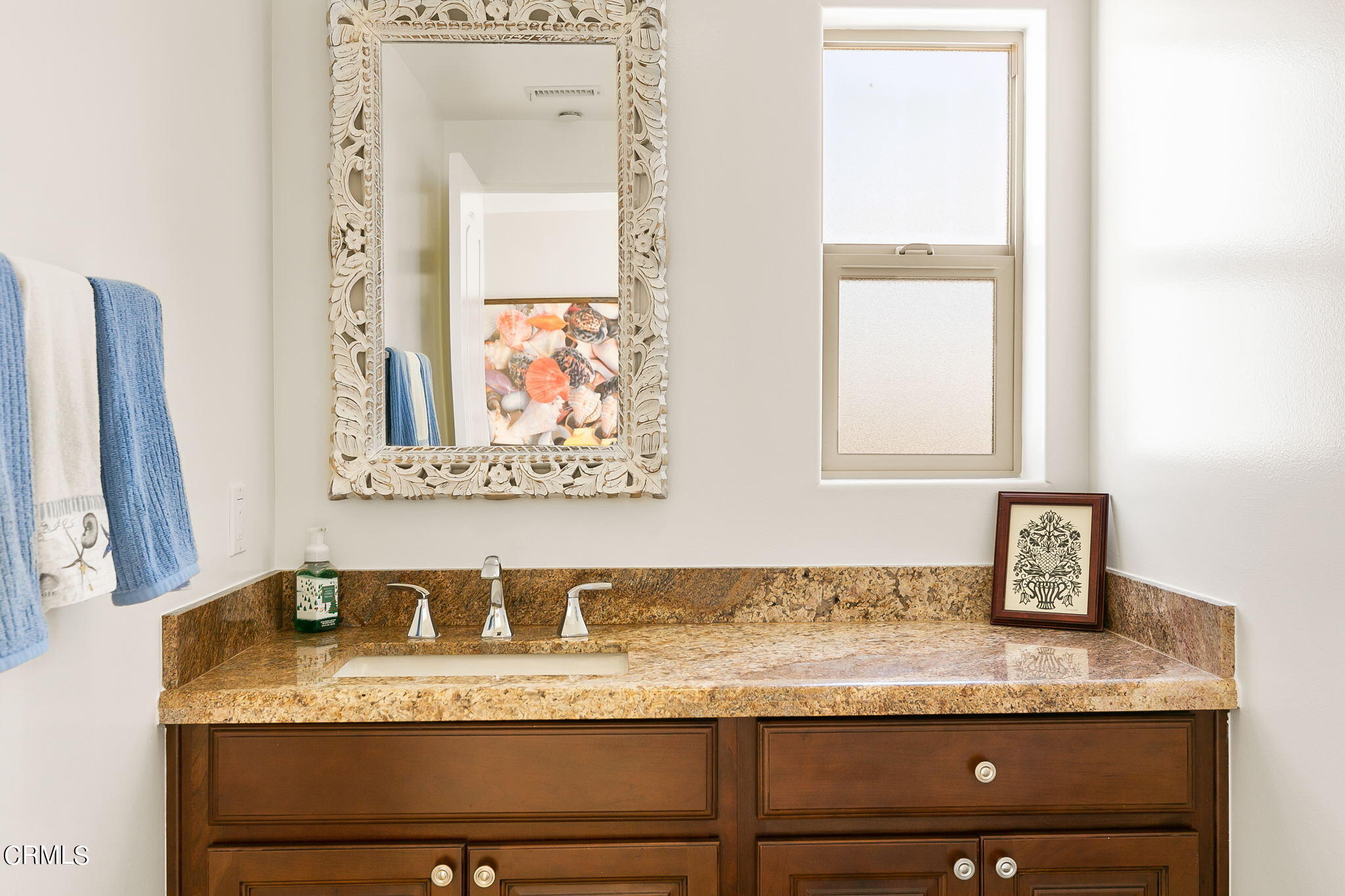 3224 Ocean Drive Oxnard, CA 93035 - Photo 32 of 52 a bathroom with a granite countertop sink and a mirror