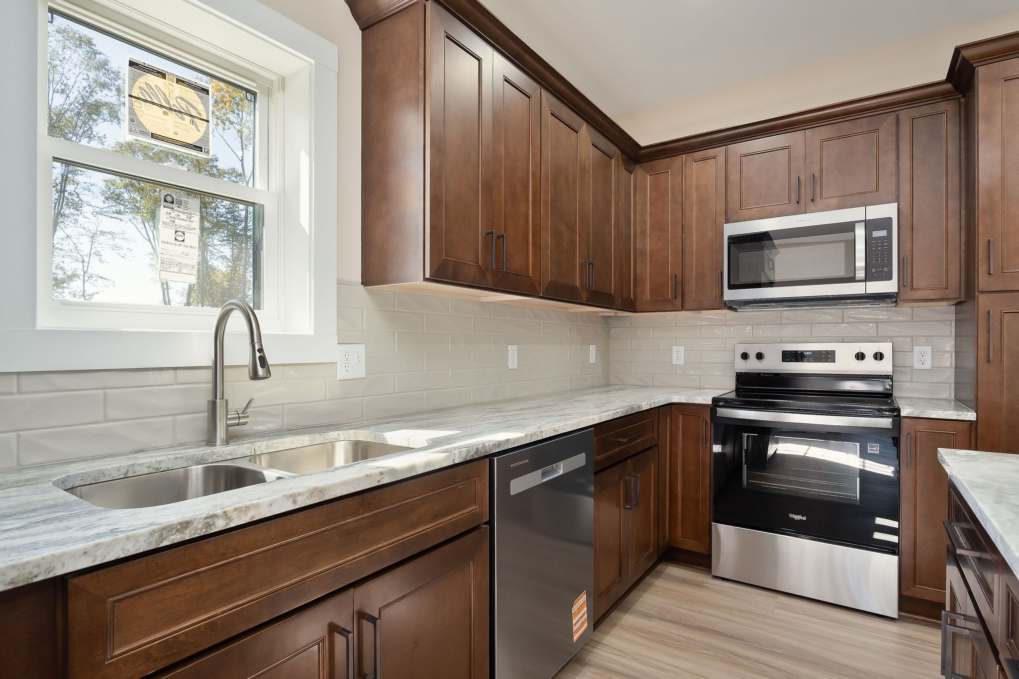 599 Hutchins Bend Road Smithville, TN 37166 - Photo 17 of 36 a kitchen with granite countertop a sink cabinets and stainless steel appliances