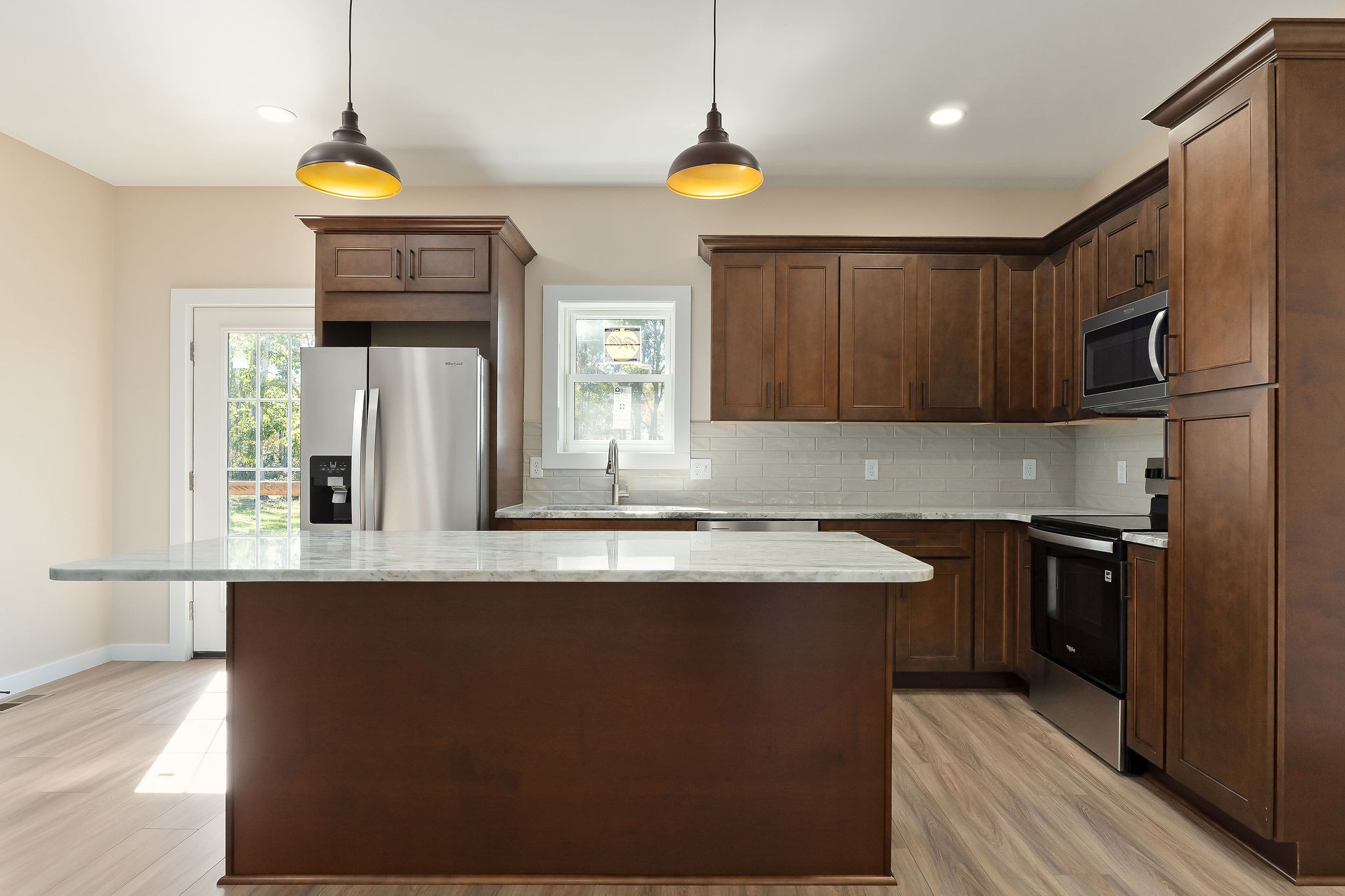 599 Hutchins Bend Road Smithville, TN 37166 - Photo 26 of 36 a kitchen with stainless steel appliances granite countertop a sink a stove and a refrigerator