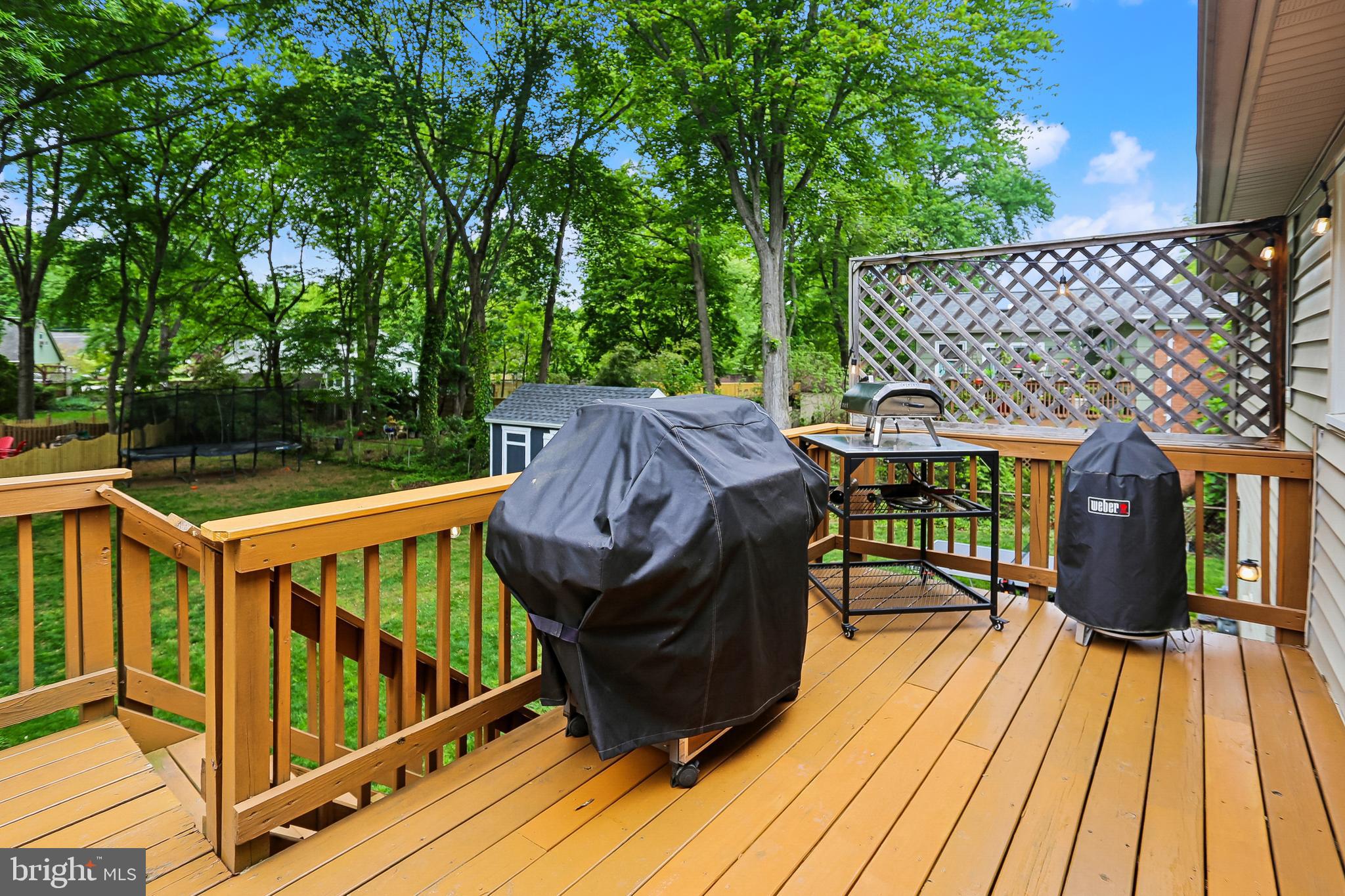 2003 Rampart Drive Alexandria, VA 22308 - Photo 13 of 38 a view of deck with table and chairs a barbeque with wooden floor and fence