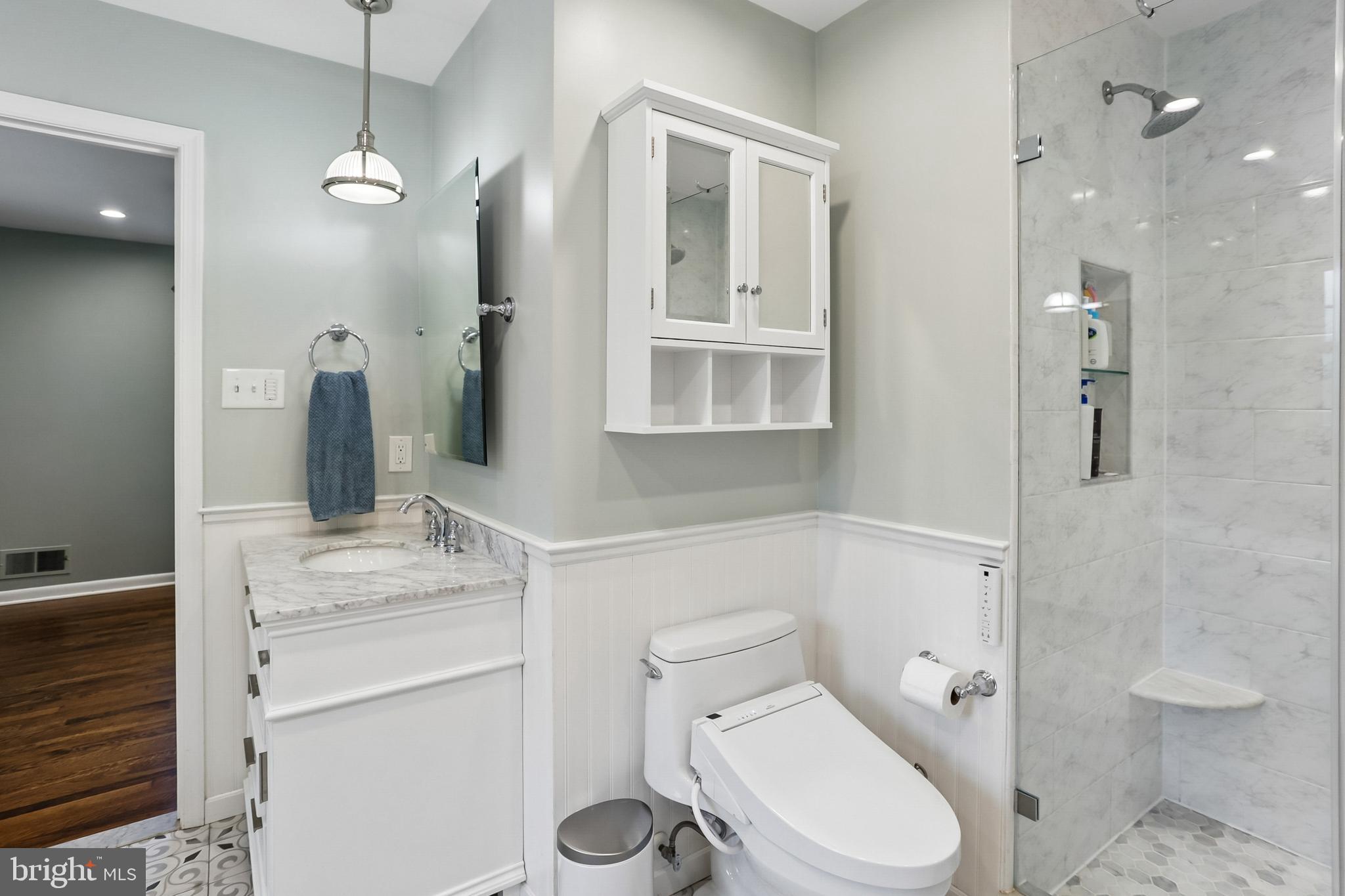 2003 Rampart Drive Alexandria, VA 22308 - Photo 19 of 38 a bathroom with a granite countertop toilet sink and shower