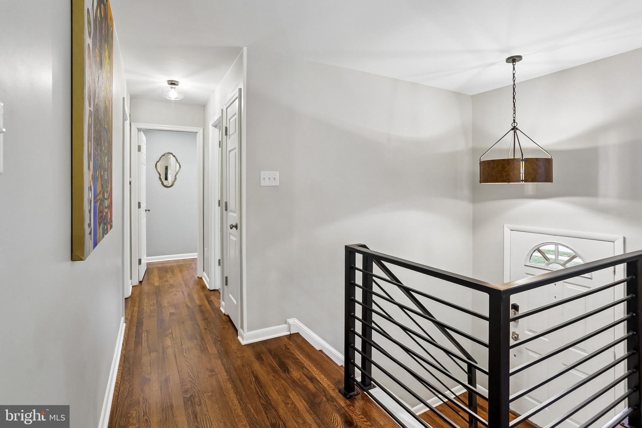 2003 Rampart Drive Alexandria, VA 22308 - Photo 23 of 38 a view of a hallway with wooden floor and staircase