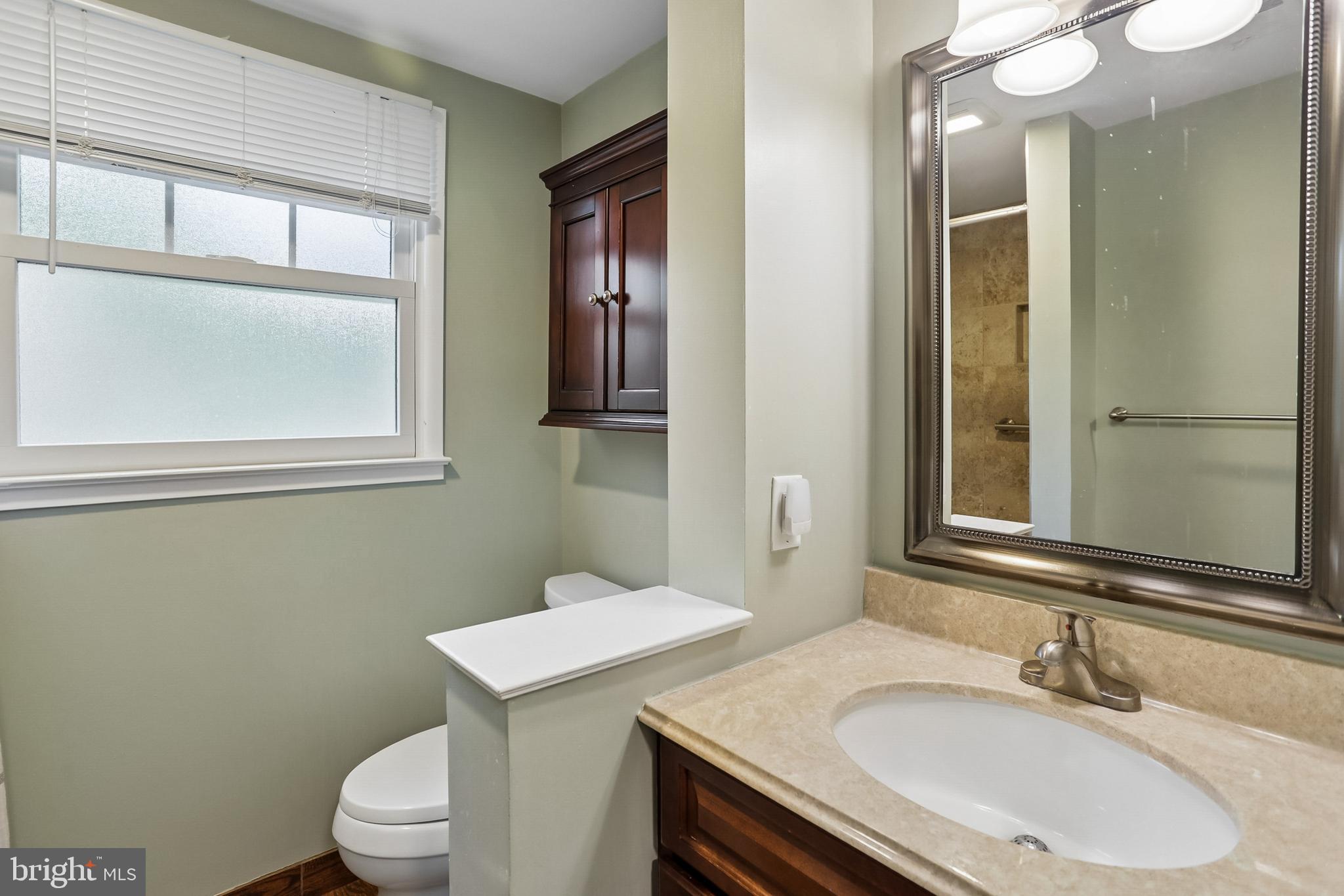 2003 Rampart Drive Alexandria, VA 22308 - Photo 30 of 38 a bathroom with a sink vanity mirror and toilet