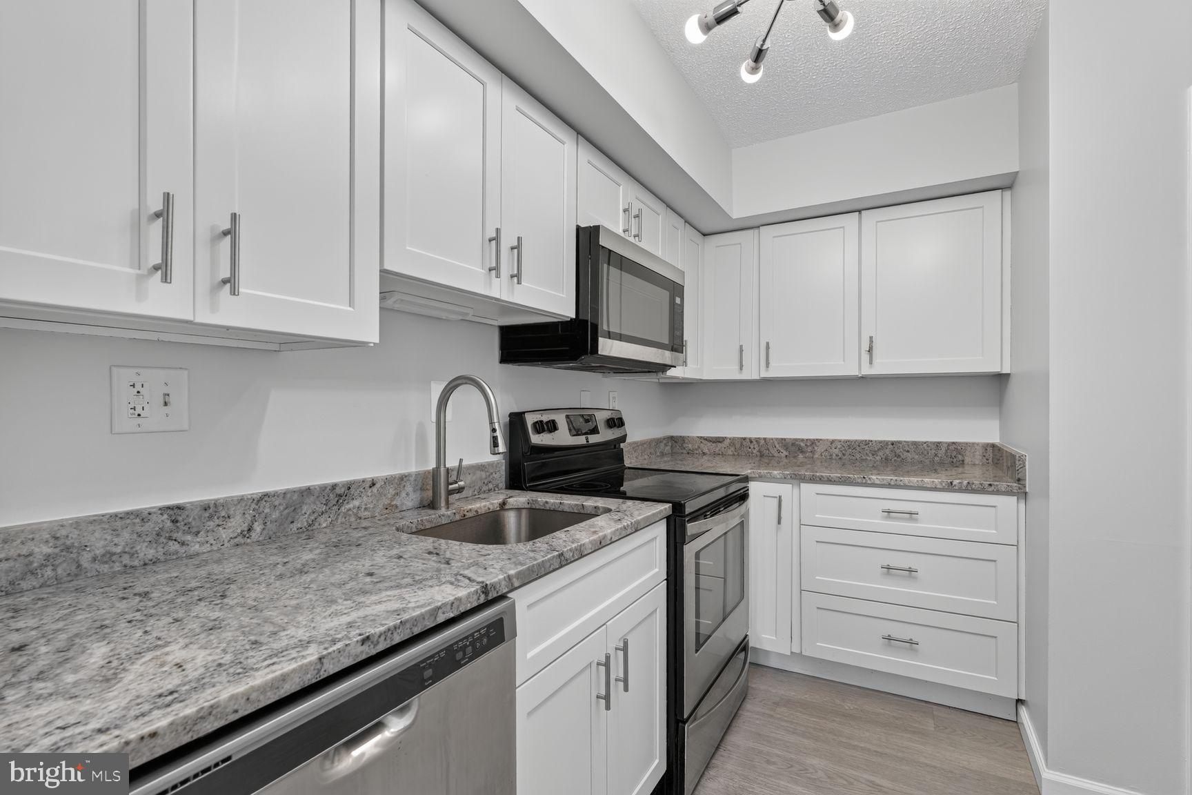 1808 Old Meadow Road, Unit 601 McLean, VA 22102 - Photo 9 of 19 Kitchen with Modern White shaker Cabinets