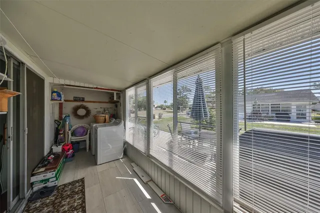 a view of a balcony with couch and wooden floor