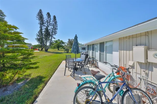 an aerial view of residential houses with outdoor space and lake view