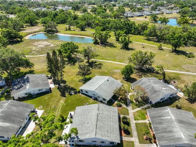 a view of a backyard with swimming pool and sitting area
