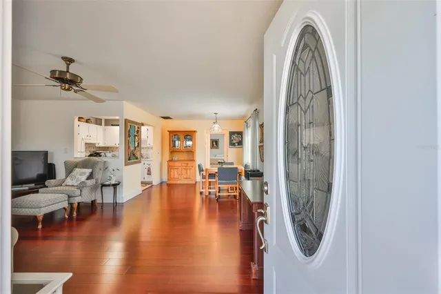 a living room with furniture flat screen tv and wooden floor