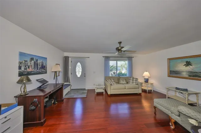 a living room with furniture flat screen tv and wooden floor