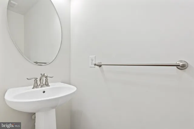 a bathroom with a sink a mirror and a shower