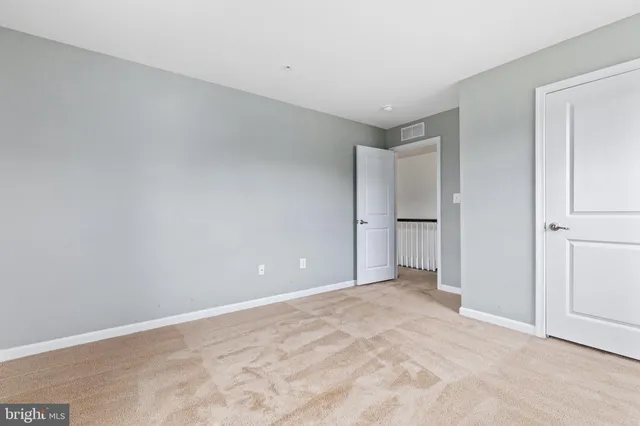 a view of an empty room with a kitchen