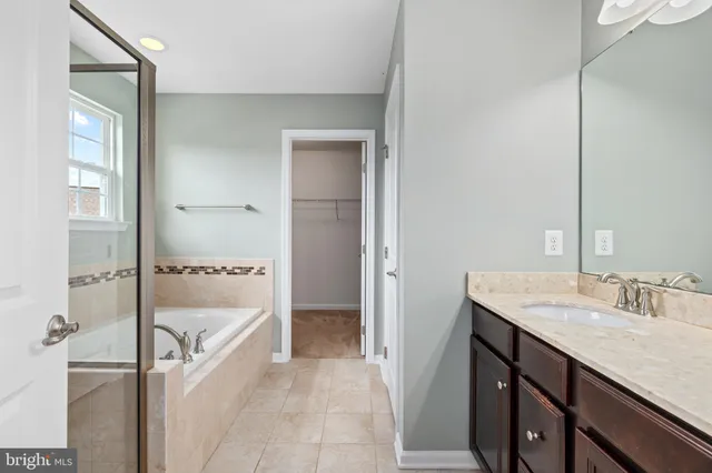 a bathroom with a tub and shower