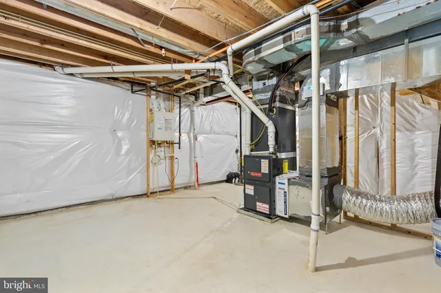 a view of an empty room with furniture and windows