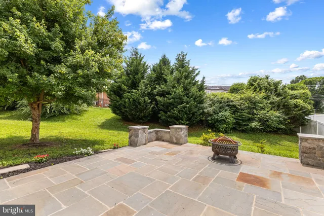 a view of a patio with table and chairs and potted plants