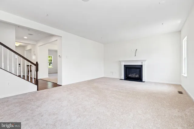 a view of an empty room with a fireplace