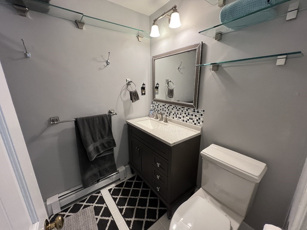 12 State Road, Unit 2E Plymouth, MA 02360 - Photo 11 of 28 a bathroom with a toilet a sink and a shower
