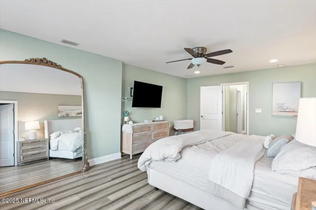 a bathroom with a sink a mirror and a potted plant on a sink