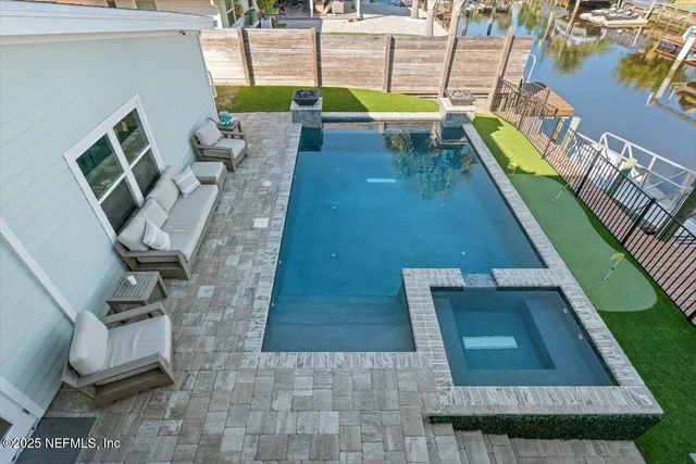 a view of a swimming pool with outdoor seating