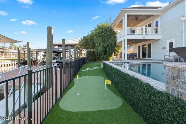 an aerial view of ocean and residential houses with outdoor space